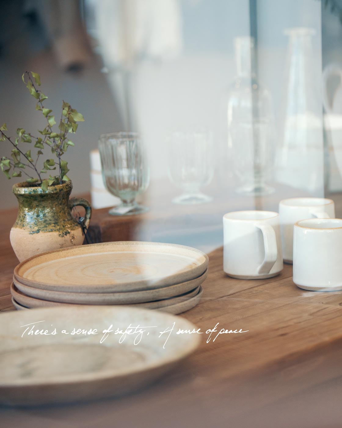 Table with mugs and plates seen through window